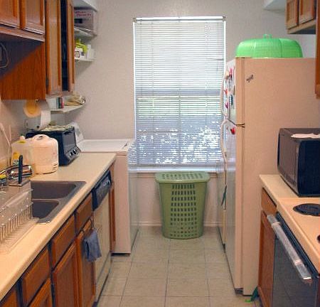 A full kitchen/laundry combo, with stove, refrigerator, washer and dryer