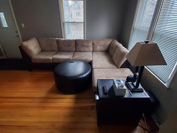 Lots of cheery light in the living room with hardwood floors.