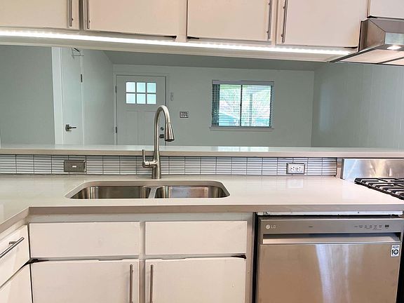 Brand new countertops, sink, dishwasher, gas stove, and stove hood.