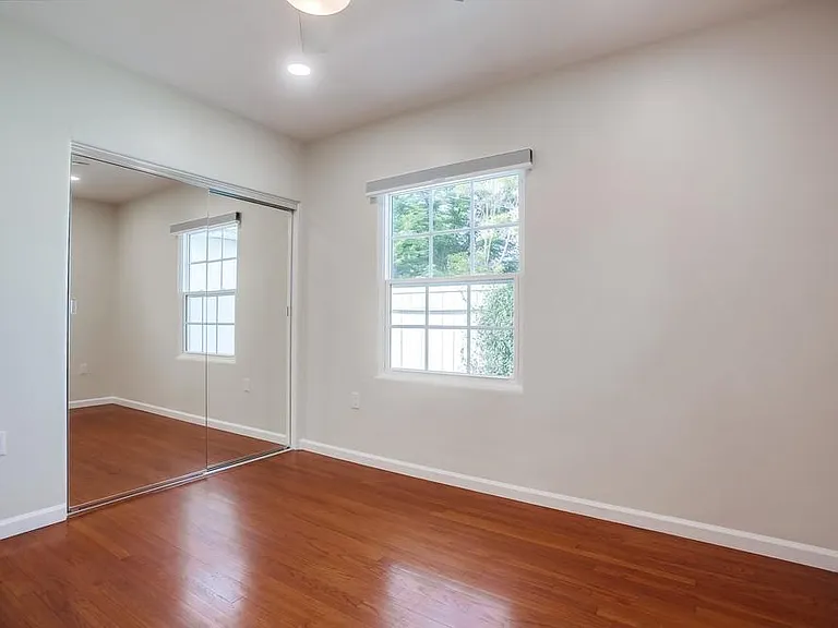 Primary bedroom with patio views and en-suite bathroom.