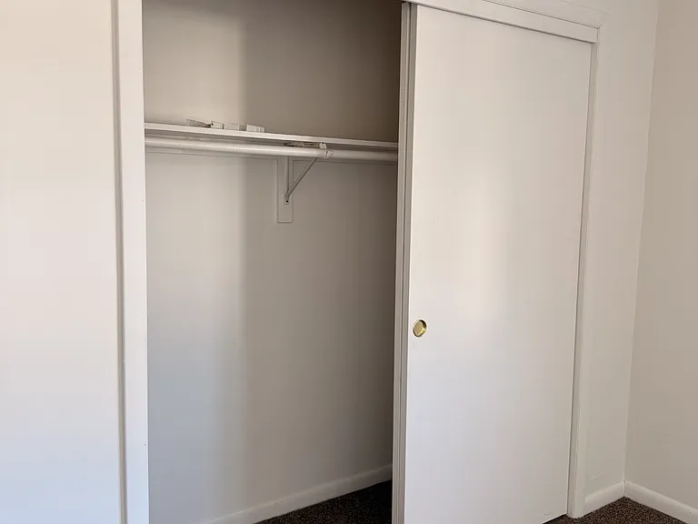 both bedrooms have large closets with lots of rooms for hanging clothes with a shelf above the pole for extra storage
