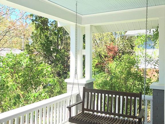 Spacious front porch with tree-top views.