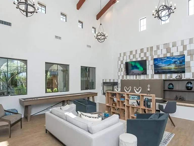 Spacious Clubhouse Featuring Lounge Seating, Wall-Mounted TVs, and Games