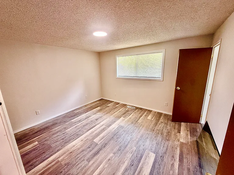 Spacious primary bedroom with large closet and private en-suite bathroom.