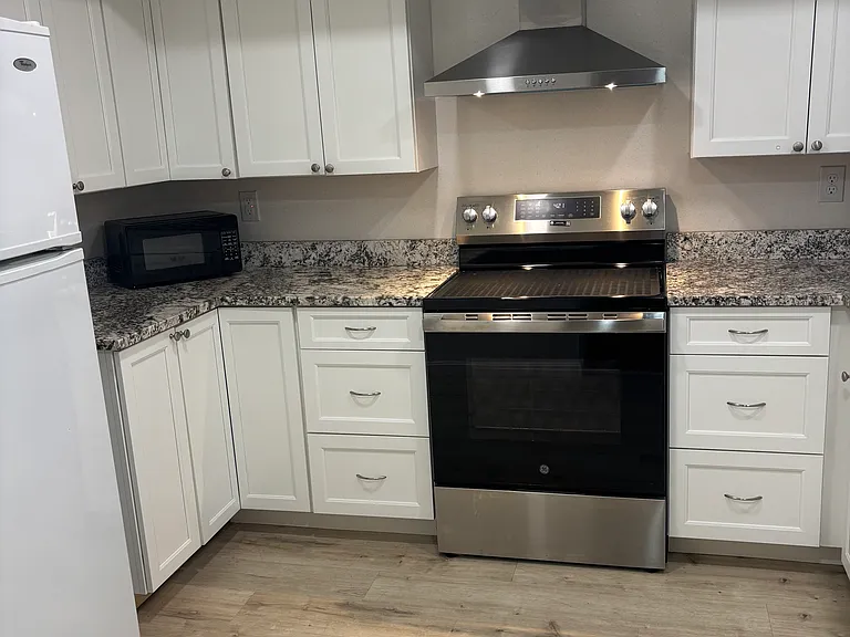 Kitchen View of Stove, Ample Cabinet Space & Lazy Susan Corner Cabinet