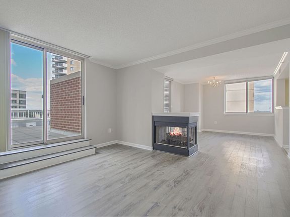 Pristine condo with a gas fireplace and a sliding door that leads to the biggest balcony in Lexington Square.