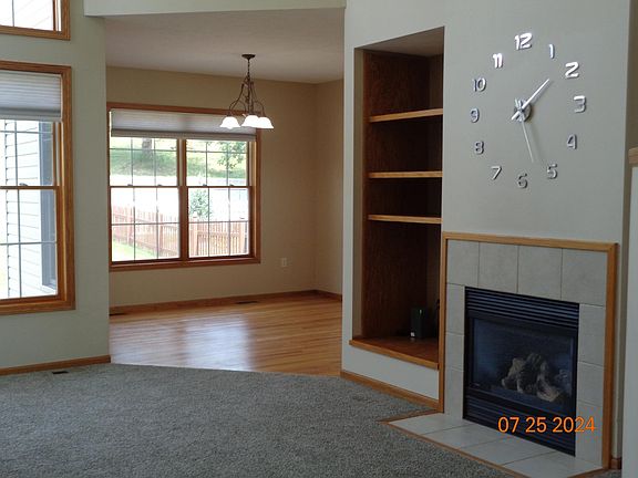 Great room. Fireplace, media area. Windows look out upon the back yards. The dining room has a wood floor.