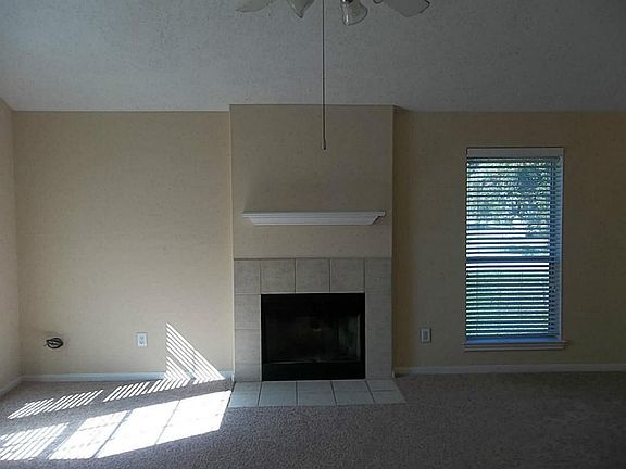 Fireplace in den with tile surround