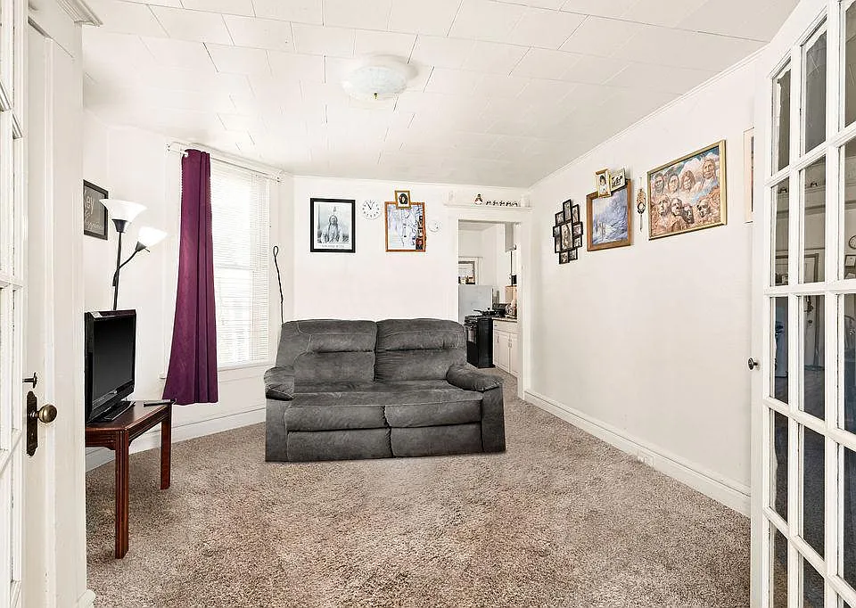Living room with passage to kitchen and bathroom.
