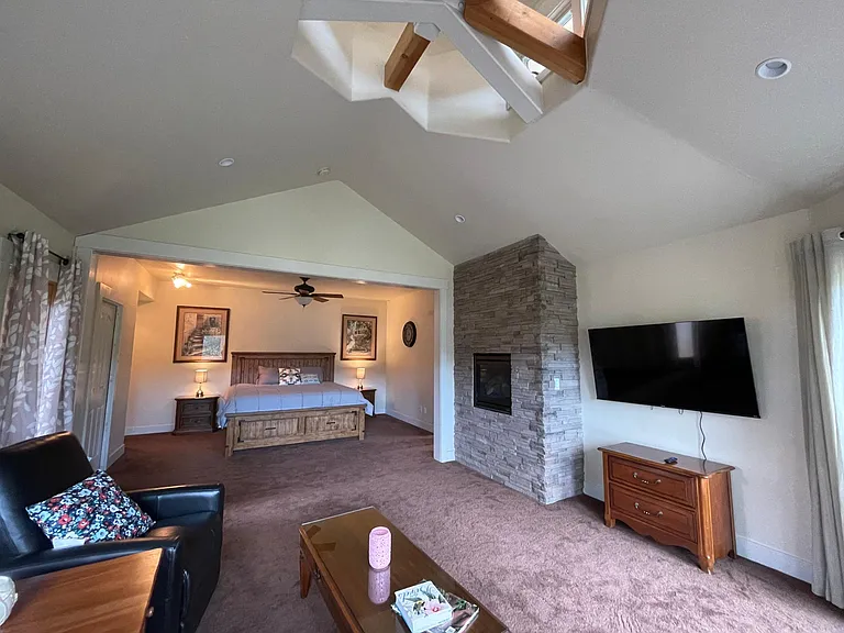 Master Suite on the lower floor with gas fireplace, flat screen TV and private seating area. Opens to a attached Patio.