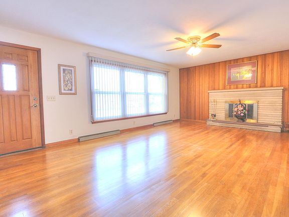 Large living room with gleaming hardwood floors.