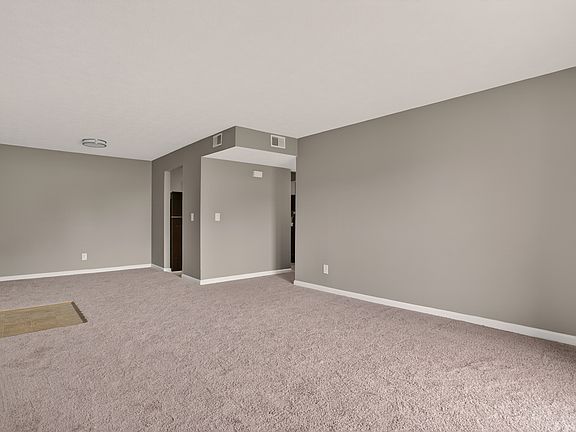 Spacious living room with carpet
