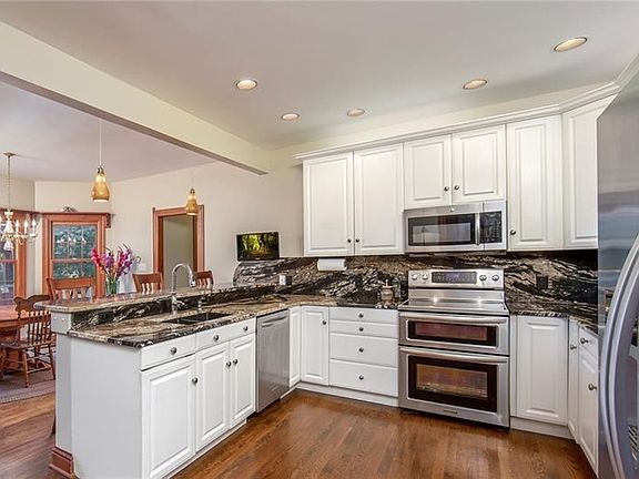 The spacious kitchen is upgraded with continuous use of the granite for countertop and backsplash.  Slide-out cutting board and 