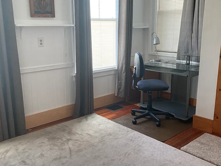 File cabinet to left of glass top desk is tucked away and fits a printer