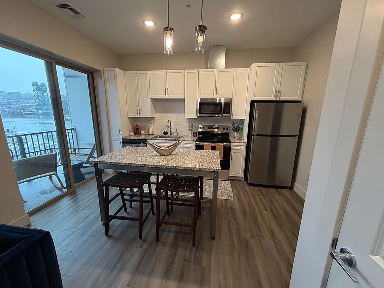 Modern kitchen and dining room with views of the river