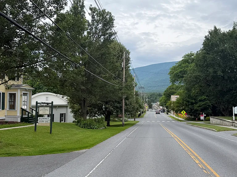 Road to Downtown with sidewalk. The sidewalk runs 1 mile North to Manchester Town Offices and 2 miles South to Manchester Village, Hearth of the Village Yoga, and the Equinox Resort. The sidewalk also runs East past rk Milies.