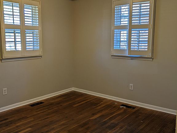 Master bedroom with fresh paint, new light, and newly refinished oak hardwood floors!