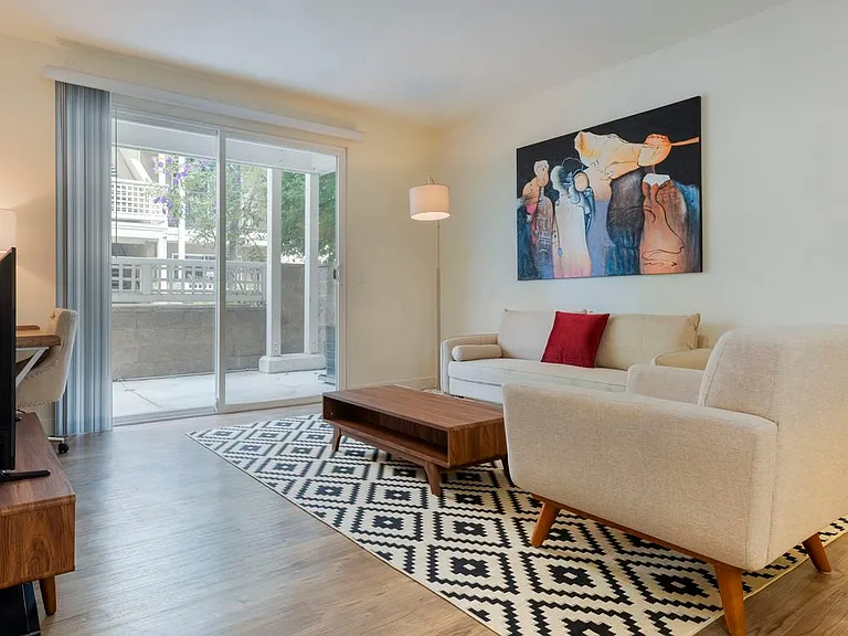 Furnished+ apartment homes come outfitted with a sofa, side chair, side table, coffee table, TV stand and 50" Television (Representative Image exact items and style of furnishings may vary)