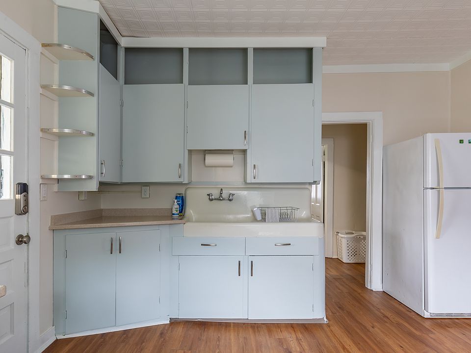 Very Large kitchen with a cast iron farmhouse sink. Door goes to the 3-season porch