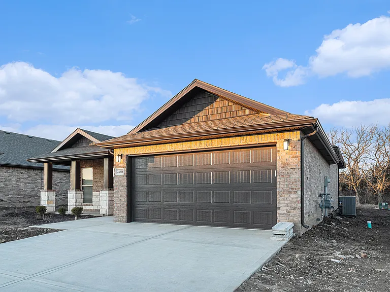 This photo was taken February 2024 before sod was laid after the new construction home build was complete. Home now has beautiful grass, complete sprinkler system and landscaping in the front of the home.