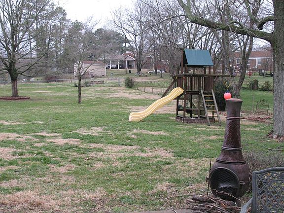 Back yard -- fireplace and outdoor play area -- all fenced in.