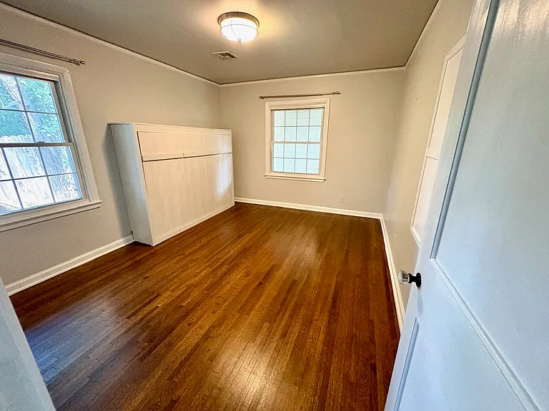 Guest bedroom with murphy bed and closet.