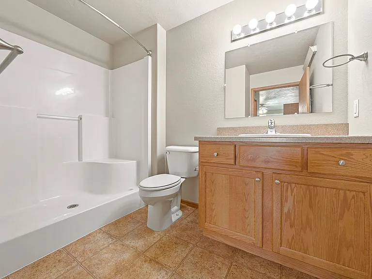 Unwind in a beautifully designed bathroom at Northdale Apartments, featuring modern fixtures and ample storage. Enjoy the comfort and convenience this space offers. Schedule your tour today and see your new home!