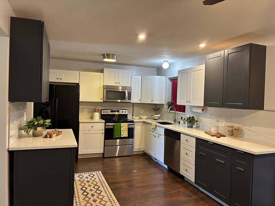 Beautiful, large updated kitchen with quartz countertops and black granite sink. Black and stainless steel applicances with flat surface stovetop.