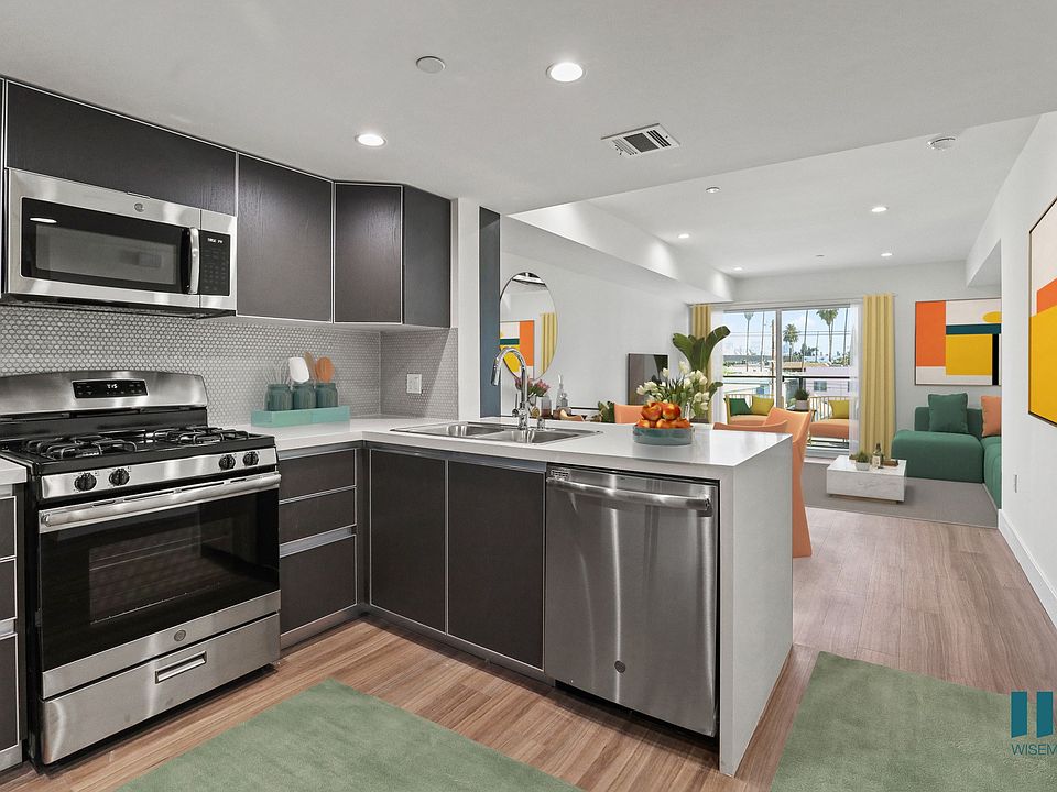 Modern Open-Concept Kitchen, Sining, and Living Room with a Patio