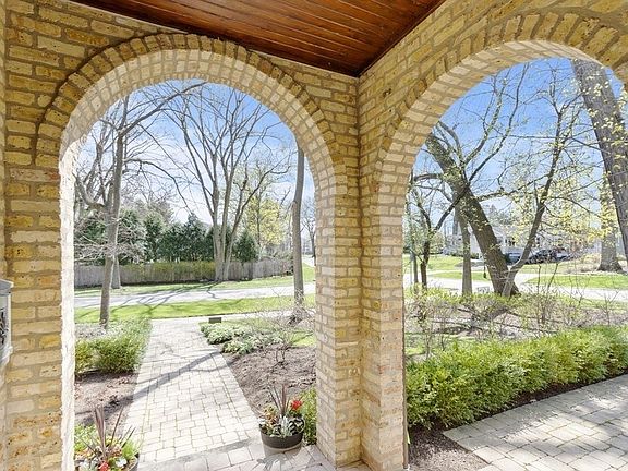 Gracious arched entry leads to front and side patios.