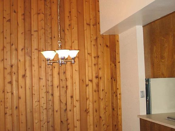 The eating area is between the kitchen and living room
