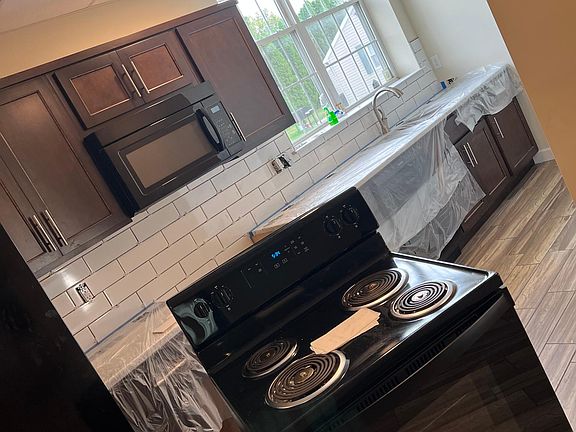 We are in the process of installing tile backsplash, brand new electric stove is being installed for the brand new house!!!