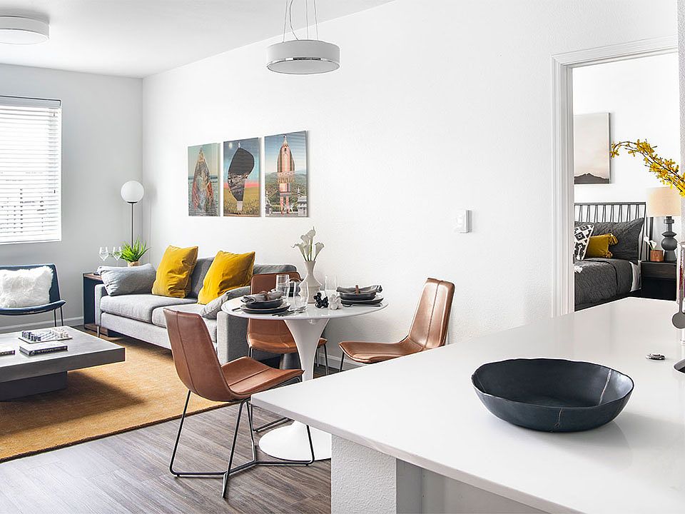 Apartment dining and living room with wood-style flooring.
