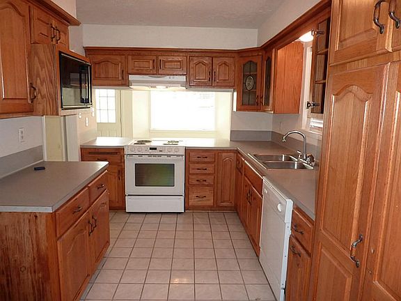 Kitchen with new stove and dishwasher - installed August 2013. Tiled flooring.