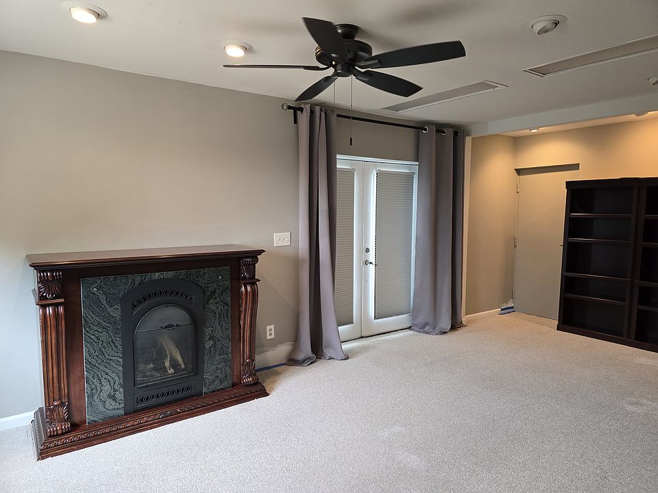 Living Space: Private French door entrance with custom room-darkening shades. Propane Fireplace and double bookcase, ceiling fan.