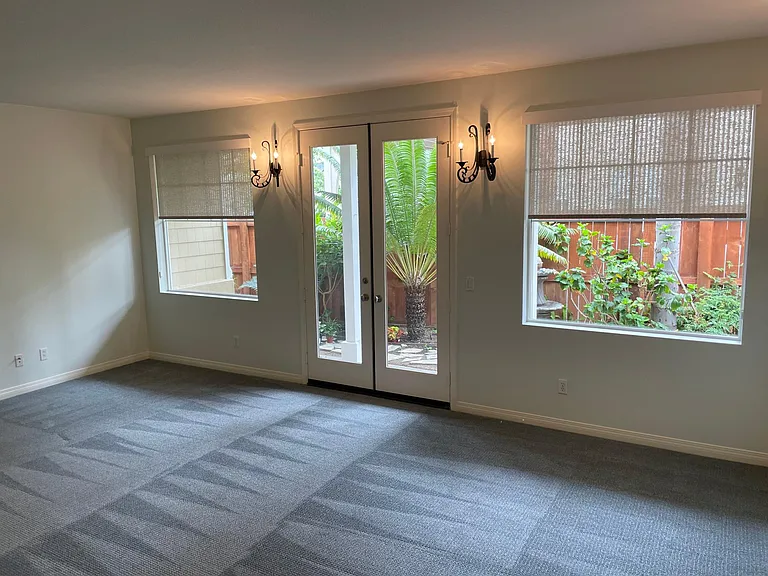 LIVING ROOM LOOKING OUT TO TROPICAL GARDEN AND FOUNTAIN