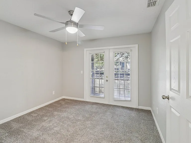 Comfortable bedroom with natural light and direct patio access