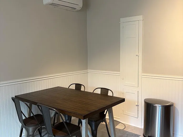 Dedicated dining nook with a four-seat table, wainscoting trim, and tile flooring for easy everyday meals.