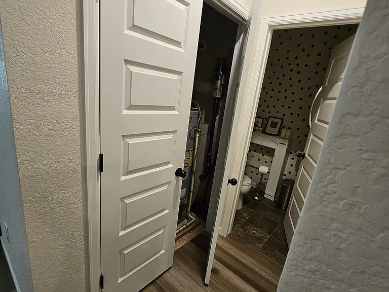 Utility closet downstairs near half bath.