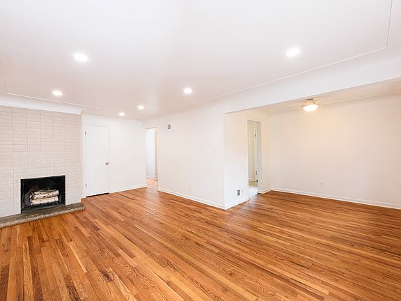 Spacious living room with several large windows and lots of natural light. Hardwood floors throughout the main level make for a clean space.