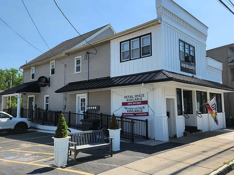 Front of building. Entrance to the upstairs apartments is just left of the retail street facing entrance