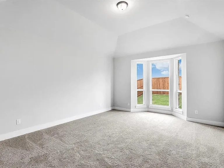 Spacious room featuring a bay window, plush carpet, vaulted ceiling, and recessed lighting