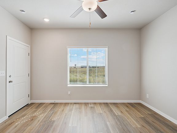 The family room is spacious with a ceiling fan.