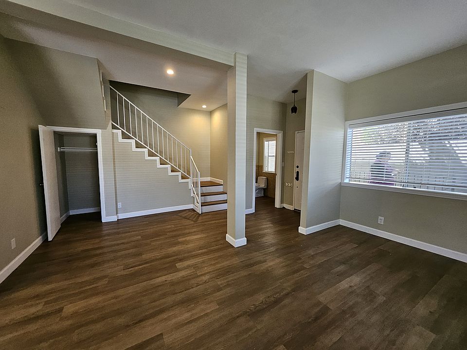 Living room looking towards front door and powder room.