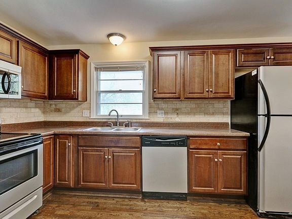 Stainless steel appliances with walnut cabinets