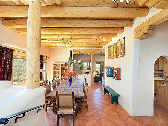 Fun and elegant entertaining in the formal, open concept dining room which opens onto the patio, with handmade iron chandelier i