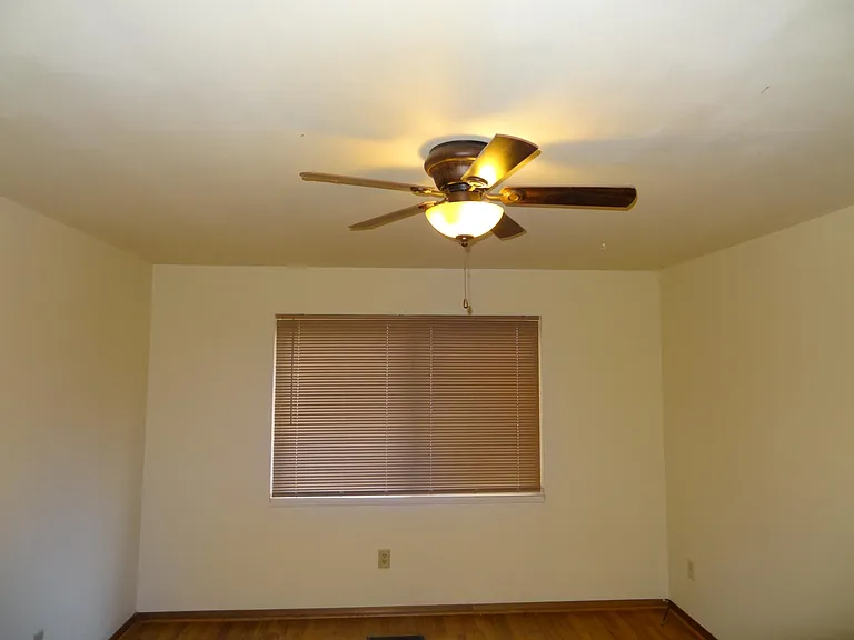 Master bed with Fan and Large welkin closet with mirror, Large window with blinds.