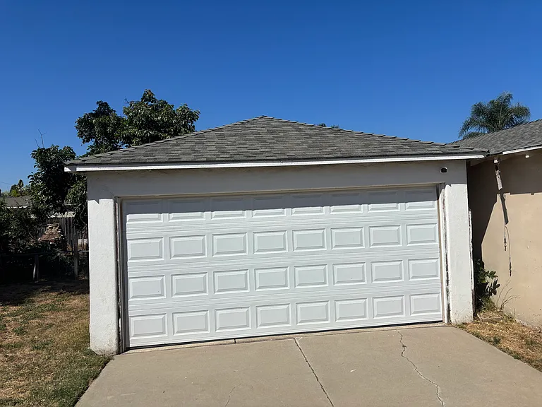 Spacious full-size garage equipped with a washer and dryer.