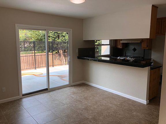 Dining Area off Living Room w/ Sliding Door view of back deck. Kitchen overlooks Dining Area