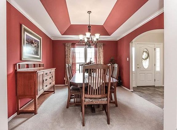 Elegant dining room with designer tray ceiling